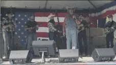  ??  ?? Borat (Sacha Baron Cohen) poses as a country singer during a political rally in “Borat Subsequent Moviefilm.”