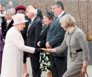  ?? ?? Theresa May greeting the Queen during the opening of Holyport College in 2014. Ref:121632-8