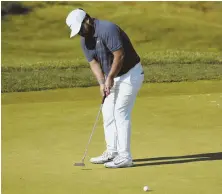  ?? AP PHOTO ?? ROLLING IT NICELY: J.J. Spaun putts on the 16th hole during his first-round 63 at yesterday’s Quicken Loans National in Potomac, Md.