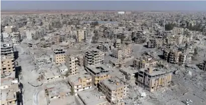  ?? AP ?? Damaged buildings in Raqqa two days after Syrian Democratic Forces said that their fighters have taken full control of the city. —