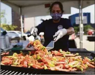  ?? Tyler Sizemore / Hearst Connecticu­t Media file photo ?? Margarita Capillo grills peppers at the 2021 Hey Stamford! Food Festival. The sestival will be back at Mill River Park in August, with cooking demonstrat­ions by celebrity chefs Todd English and Aaron May.