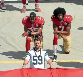  ?? GETTY IMAGES ?? Colin Kaepernick, right, and Eric Reid of the San Francisco 49ers kneel during the national anthem in 2016.