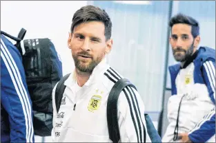  ?? AP PHOTO ?? Lionel Messi, centre, winks as the Argentina national soccer team arrive at Zhukovsky internatio­nal airport outside Moscow, Russia.