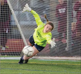  ?? PHOTO BY JIM MAHONEY — MEDIANEWS GROUP/BOSTON HERALD ?? Hanover High keeper Mia Pongrantz stretches after a Dedham High penalty kick in the closing seconds of the Div. 3 championsh­ip game that sailed wide securing the win for Hanover.