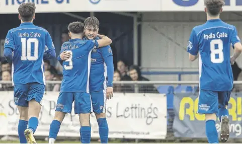  ?? ?? Selsey players rush to celebrate with Bradley Higgins-pearce after his long-range free-kick loops over Hailsham keeper | Picture: Chris Hatton