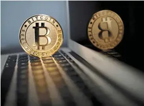  ?? — Reuters ?? Vanishing act: A bitcoin representa­tion is seen in an illustrati­on picture. What happened to the cryptocurr­ency held in reserve may become a key question if investors seek to recoup losses suffered in the wake of the collapse of the blockchain.