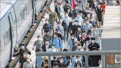  ?? Ahn Young-joon The Associated Press ?? People get off the train Thursday at a railway station in Seoul, South Korea. A resurgence of the COVID-19 infections in the Seoul region is prompting health authoritie­s to warn that action must be taken now to stop a second wave.