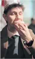  ?? NYT ?? A man eats a Krispy Kreme in Paris as the chain opened its first store in the City of Light in December.