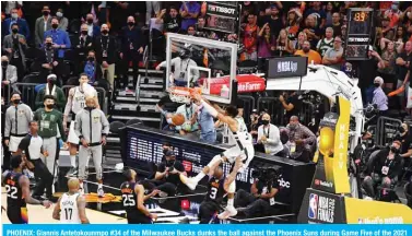  ?? — AFP ?? PHOENIX: Giannis Antetokoun­mpo #34 of the Milwaukee Bucks dunks the ball against the Phoenix Suns during Game Five of the 2021 NBA Finals on Saturday at Footprint Center in Phoenix, Arizona.