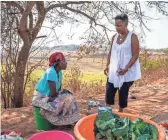  ?? JARRAD HENDERSON/USA TODAY ?? USA TODAY reporter Deborah Berry greets a villager near Malanje, Angola.