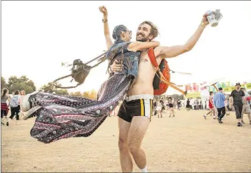  ?? ERIKA RICH / FOR AMERICAN-STATESMAN ?? The best accessory at a festival is a spirit of adventure and fun, as Jonathan Amstead and Jacqueline Marie demonstrat­e at ACL Fest 2015.