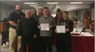  ?? KEVIN MARTIN — THE MORNING JOURNAL ?? On Nov. 19 the Lorain City Schools Board of Education recognized two scholars, Rico Mercado (front center) and Sariana Rivera (front right) with certificat­es of recognitio­n for their performanc­e on the ACT exam.