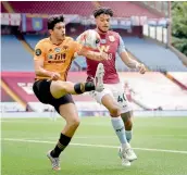  ?? AP ?? Raul Jimenez of the Wolverhamp­ton Wanderers (left) vies for the ball with Aston Villa’s Tyrone Mings during their English Premier League match at Villa Park in Birmingham on Saturday. The Wolves won 1-0. —