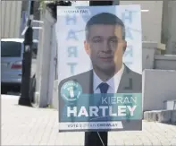  ??  ?? Posters of Kieran Hartley and an upside-down Simon Harris.