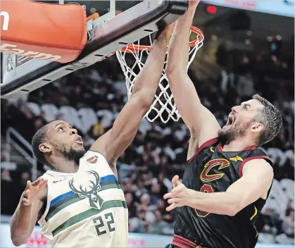  ?? TONY DEJAK THE ASSOCIATED PRESS ?? Milwaukee Bucks' Khris Middleton blocks a shot by Cleveland Cavaliers' Kevin Love in a game on Monday.