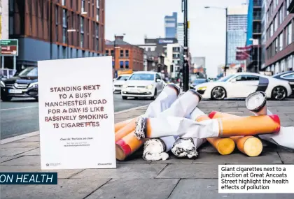  ??  ?? Giant cigarettes next to a junction at Great Ancoats Street highlight the health effects of pollution