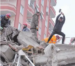  ?? ?? l Rescatista­s buscan a personas desapareci­das en un edificio que se desplomó tras el terremoto del lunes, en Adana, Turquía.