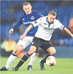  ??  ?? Everton’s Wayne Rooney (left) vies with Atalanta’s Timothy Castagne during their Group E match at Goodison Park in Liverpool, north west England. — AFP photo