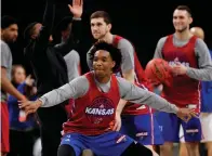  ?? Associated Press ?? ■ Kansas guard Devonte' Graham participat­es in a drill during a practice session for the Final Four NCAA college basketball tournament Friday in San Antonio.