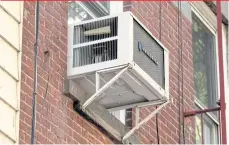  ??  ?? An air conditione­r compressor sits beneath the window of an apartment in New York City.