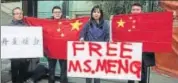  ?? AP ?? Supporters hold signs and flags outside a court in Vancouver on Tuesday during the bail hearing for Meng Wanzhou.