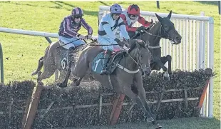  ?? Picture: Getty Images. ?? Brendan Powell and Shufoog clear the last to win the ROA/Racing Post Owners’ Jackpot Mares’ Handicap Hurdle at Warwick yesterday.