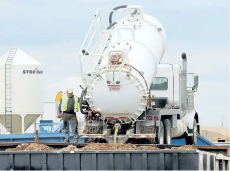  ?? TED RHODES/CALGARY HERALD FILES ?? A truck unloads material at the Tervita Treatment Recovery Disposal operation in Alexander, N.D. Tervita is selling its service rig business while trying to renegotiat­e a $2.5-billion debt.