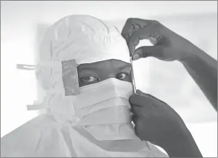  ?? JEROME DELAY/AP ?? A nurse is prepared with personal protection equipment before entering a high risk zone of an Ebola isolation and treatment center in Monrovia, Liberia.