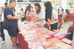  ??  ?? The Ang Pow Collectors Group sets up a booth selling ang pow packets – all for charity.