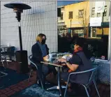  ?? RICH FREEDMAN — TIMES-HERALD ?? Bambino’s offers heat lamps near two outdoor tables. The mild lunchtime temperatur­e Monday wasn’t cold enough to turn the one one by the two diners, above.