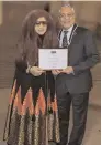  ??  ?? India’s herbal cosmetics queen Shahnaz Husain (left) receives an award from Lord Patel of Bradford at the House of Lords in London recently.