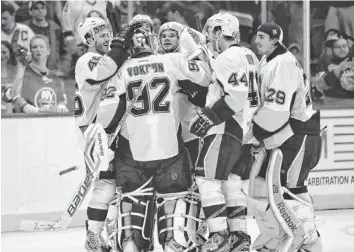  ?? AP ?? Penguins players, including defenseman Brooks Orpik (44), celebrate after beating the Islanders on Saturday.
