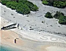  ?? PHOTO: WASHINGTON POST ?? A pair of stranded mariners signal for help by writing ‘‘SOS’’ in the sand as a US Navy P-8A Poseidon aircraft crew from Patrol Squadron (VP) 8 flies over in support of a Coast Guard search and rescue mission.