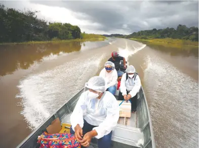  ?? REUTERS ?? salud viajan a lo largo del río Solimoes, donde viven ribeirinho­s (habitantes del río), para aplicar la vacuna de AstraZenec­a/Oxford en el estado de Amazonas/