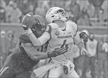  ?? Associated Press ?? Fumble: Arkansas quarterbac­k Ty Storey, right, fumbles the ball as he is hit by Missouri defensive lineman Jordan Elliott, left, during the first half of their game Friday in Columbia, Mo.