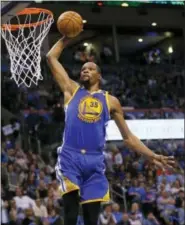  ?? SUE OGROCKI — THE ASSOCIATED PRESS ?? In this Feb. 11, 2017, file photo, Golden State Warriors forward Kevin Durant (35) goes up for an unopposed dunk in the second quarter of an NBA basketball game against the Oklahoma City Thunder, in Oklahoma City.