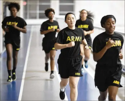 ?? BOB ANDRES / ROBERT.ANDRES@AJC.COM ?? Three days a week, Emory student Jihea Song (center) does physical training at Georgia Tech with ROTC students. She finds that a regimented daily routine in her campus life, much like that of her Army days, has helped her adjust.