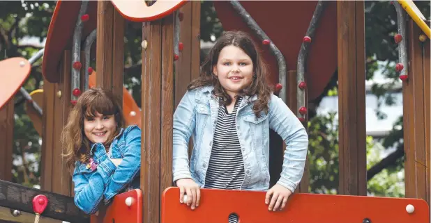  ?? Picture: BRENDAN RADKE ?? RUGGED UP: Sofia Kendjelic, 7, and friend Bella East, 7, didn't let the cold stop them from having fun at Muddy's Playground on the Esplanade.