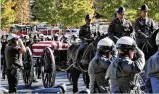  ?? BOB ANDRES / BANDRES@AJC.COM ?? Officers salute the passing of the caisson bearing the casket of slain Gwinnett police officer Antwan Toney en route to his funeral on Oct. 24.