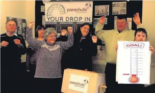  ??  ?? ●● Volunteers and ‘dropper-inners’ at Parachute drop-in, in Macclesfie­ld