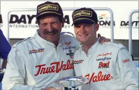  ?? ASSOCIATED PRESS FILE PHOTO ?? Dale Earnhardt, left, hugs Dale Earnhardt Jr. in Victory Lane on Feb. 18, 2000, after the elder Earnhardt won the Internatio­nal Race of Champions round at the Daytona Internatio­nal Speedway. The younger Earnhardt finished fifth in that race. As he prepares to join his late father in the NASCAR Hall of Fame, Dale Earnhardt Jr. can’t help but wonder what his Dad would make of the career he’s built on and off the track.