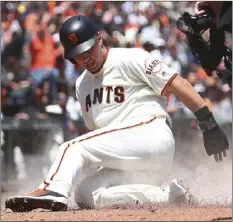  ??  ?? San Francisco Giants’ Joe Panik slides to score in the third inning of a baseball game against the Arizona Diamondbac­ks on Wednesday in San Francisco. Panik scored on a double by Giants’ Andrew McCutchen. AP PHOTO/BEN MARGOT