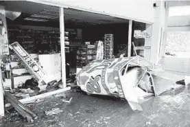  ?? VICTOR RUIZ GARCIA/AP ?? A shattered storefront Wednesday in Mexico after Hurricane Delta made landfall south of Cancun as a Category 2 storm. Delta may strengthen into a Category 3 storm this week.