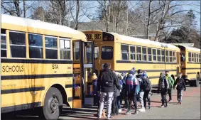  ?? Tyler Sizemore / Hearst Connecticu­t Media ?? Students board a bus bound for a different school at North Mianus School in the Riverside section of Greenwich on March 2.