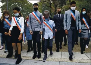  ?? LLUDOVIC MARIN — POOL ?? Young representa­tives of the municipal council attend a ceremony with French President Emmanuel Macron in Les Mureaux, northwest of Paris on Friday.