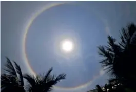  ?? — GANDHI ?? A circular halo is seen around the sun in Hyderabad on Wednesday. Experts called it a natural phenomenon that occurs depending on the clarity in the sky.