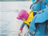  ?? Provided by Bobby Marko ?? Rowan Marko tests the water. “Everyone asks, ‘Don't the kids want to jump out?’ ” Maura said. “But no. They both can sit in a canoe for such a long time.”