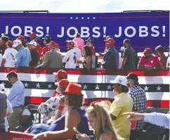  ?? BRENDAN SMIALOWSKI / AFP via Gett y Imag es files ?? Supporters listen in August as President Donald Trump delivers remarks in Wisconsin on the economy.