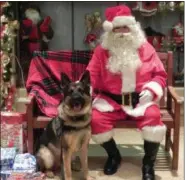  ?? DIGITAL FIRST FILE PHOTO ?? In this photo from last year’s “Seven Days Before Christmas” event, two of Norristown Police Department’s finest made sure the night had just the right holiday spirit.