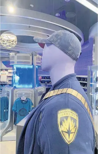  ?? DEWAYNE BEVIL/ORLANDO SENTINEL PHOTOS ?? A mannequin wearing pieces from the Honorary Guardians collection looks out over Epcot’s Treasures of Xandar store, attached to the park’s indoor roller coaster named Guardians of the Galaxy: Cosmic Rewind.